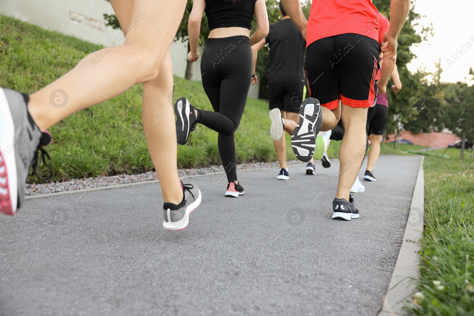 Photo of Group of people running outdoors, closeup view