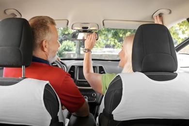 Loving senior couple sitting together in car