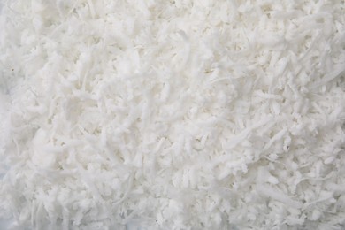 Photo of Fresh coconut flakes as background, top view