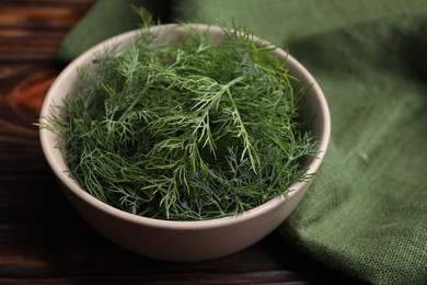 Photo of Bowl of fresh dill on table, closeup