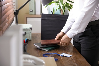 Photo of Businessman with moving box in office, closeup. Work promotion concept