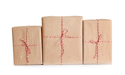 Photo of Beautifully wrapped gift boxes on white background