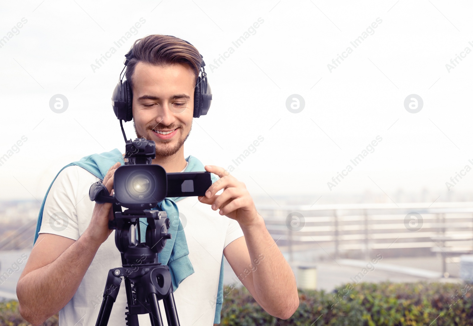 Image of Video operator with camera working on city street