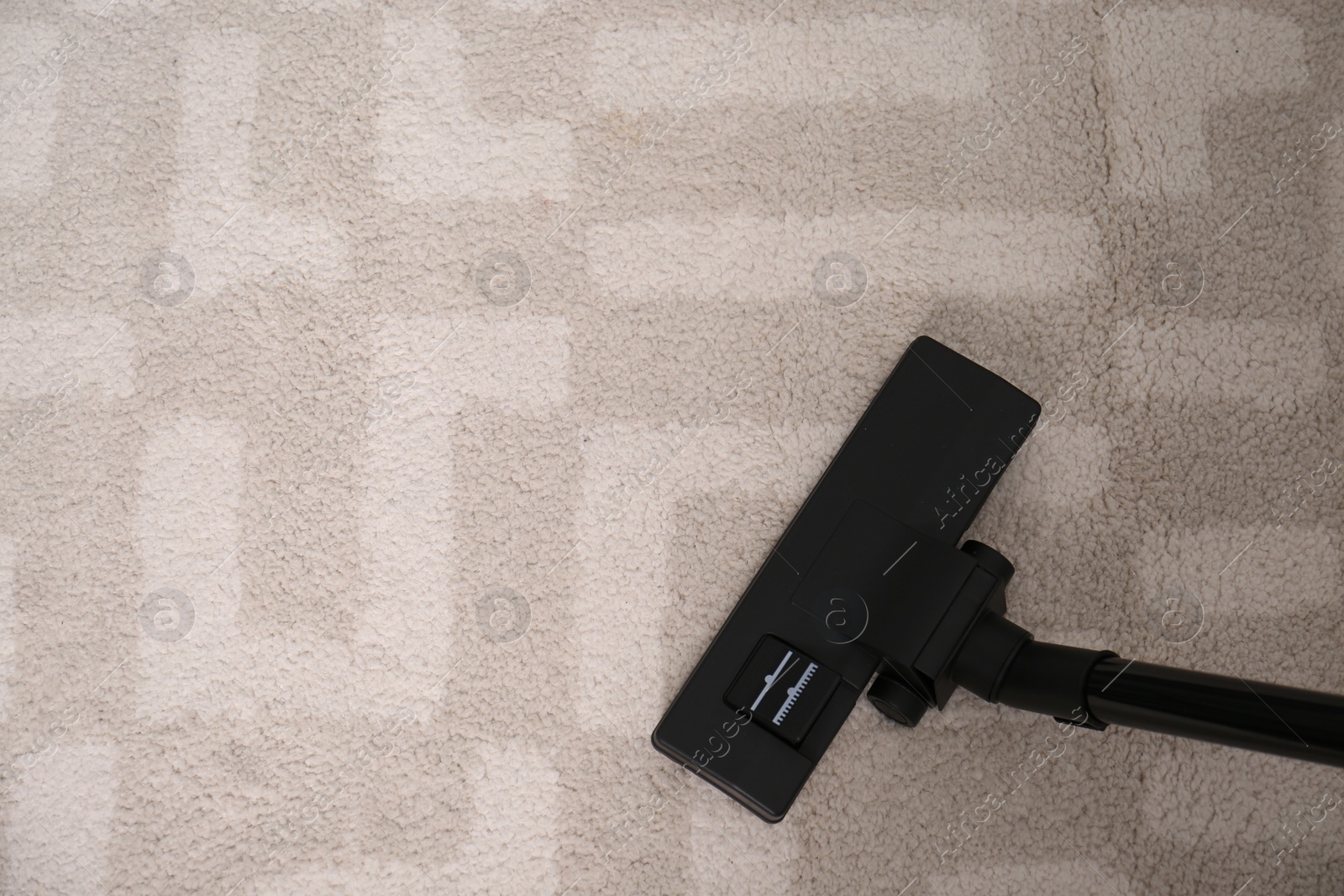 Photo of Hoovering floor with modern vacuum cleaner, top view. Space for text