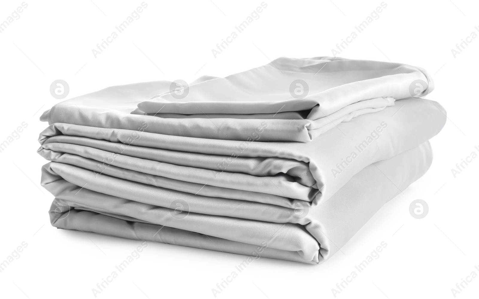 Photo of Stack of clean silky bed linen isolated on white