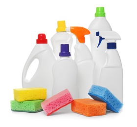 Different cleaning products and sponges on white background