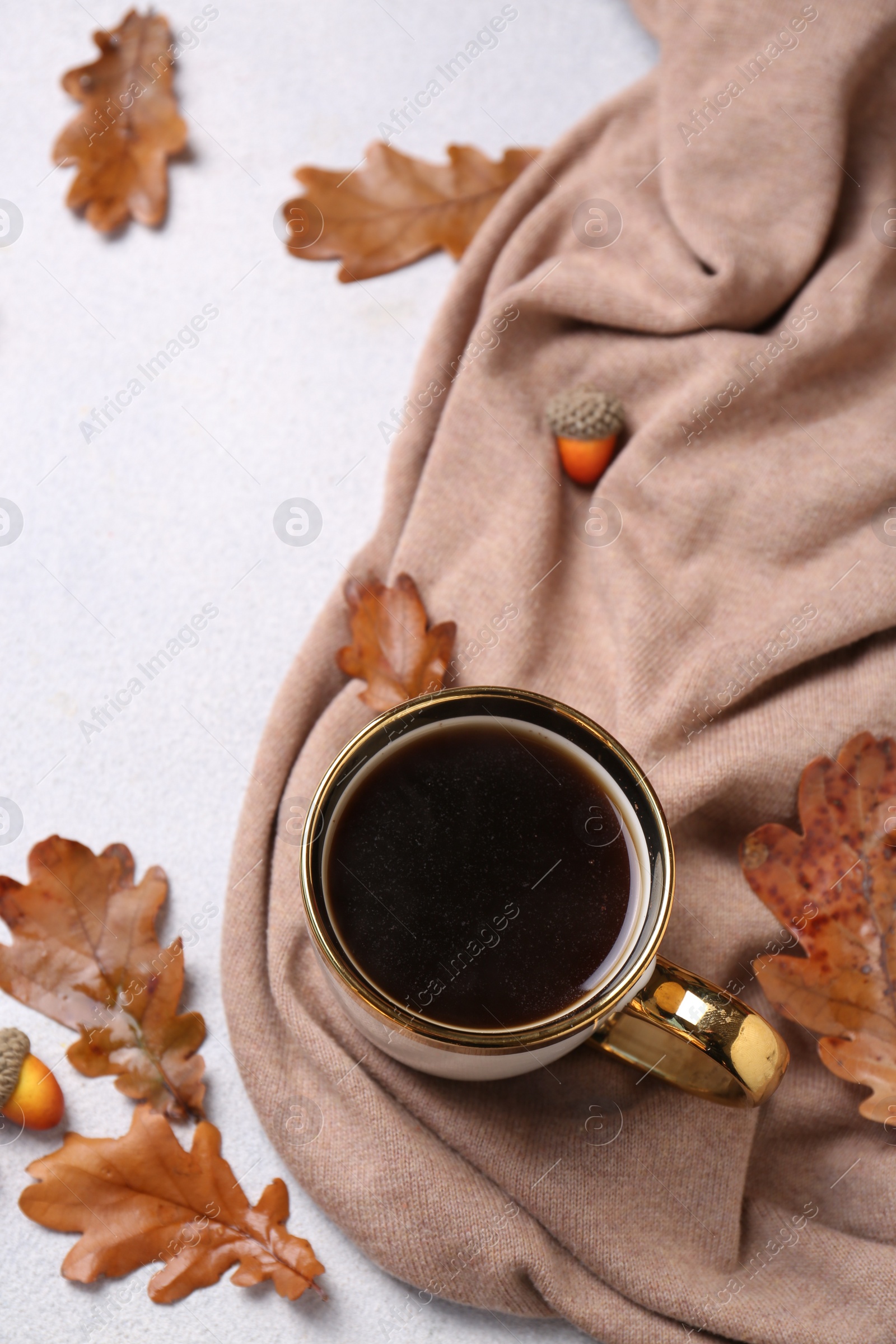 Photo of Flat lay composition with cup of hot drink and autumn leaves on light grey textured table