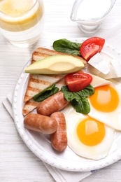 Photo of Delicious breakfast with fried eggs on white wooden table, flat lay