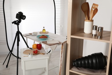 Photo of Professional equipment and composition with spaghetti on white wooden table in studio. Food photography