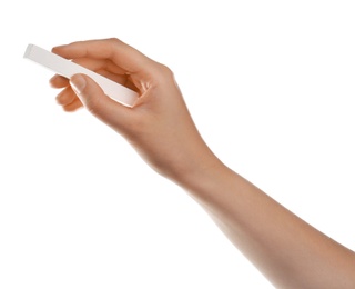 Woman holding piece of chalk on white background