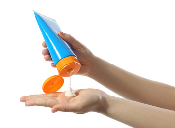 Woman applying sun protection cream on hand against white background, closeup