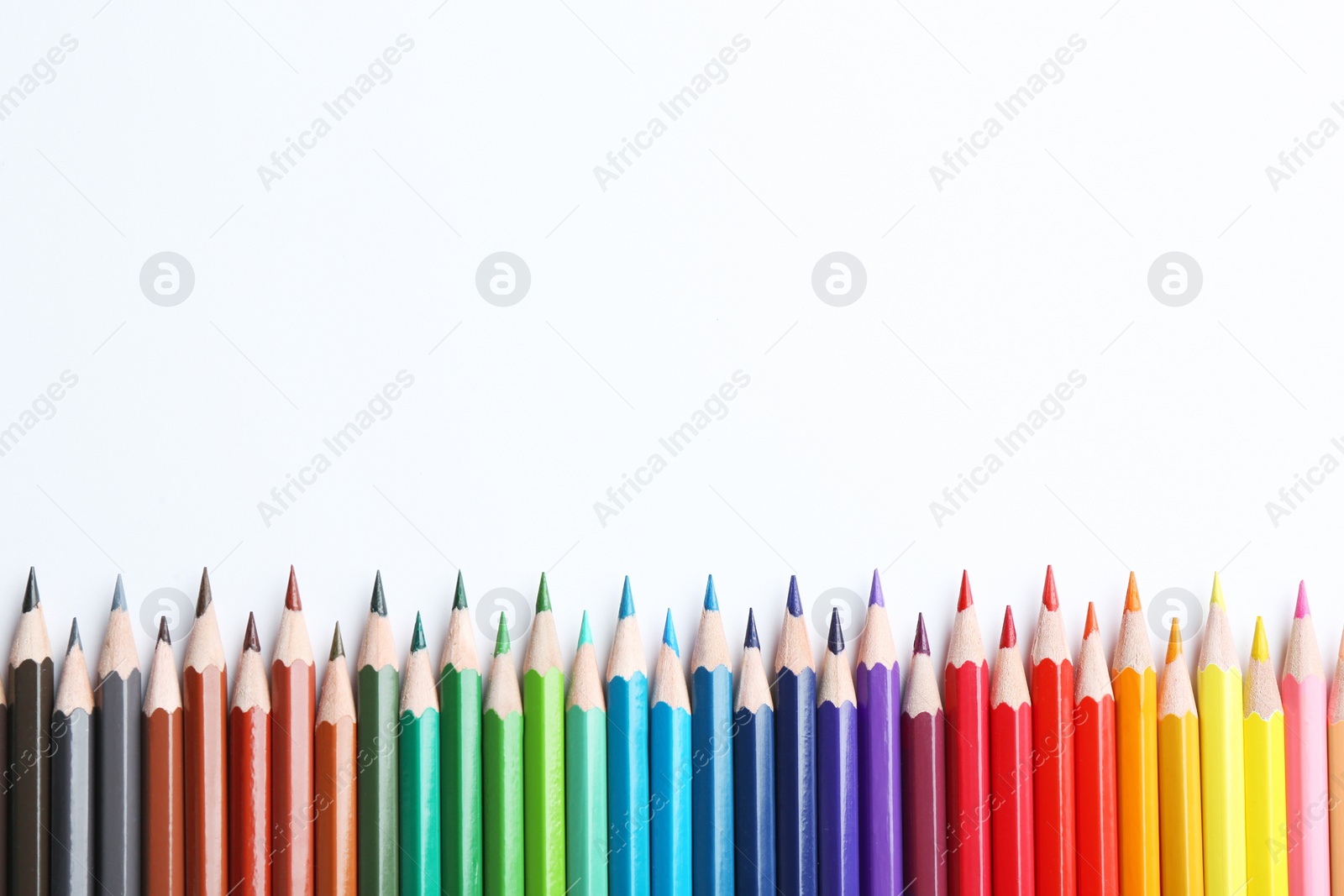 Photo of Composition with color pencils on white background, flat lay. Space for text