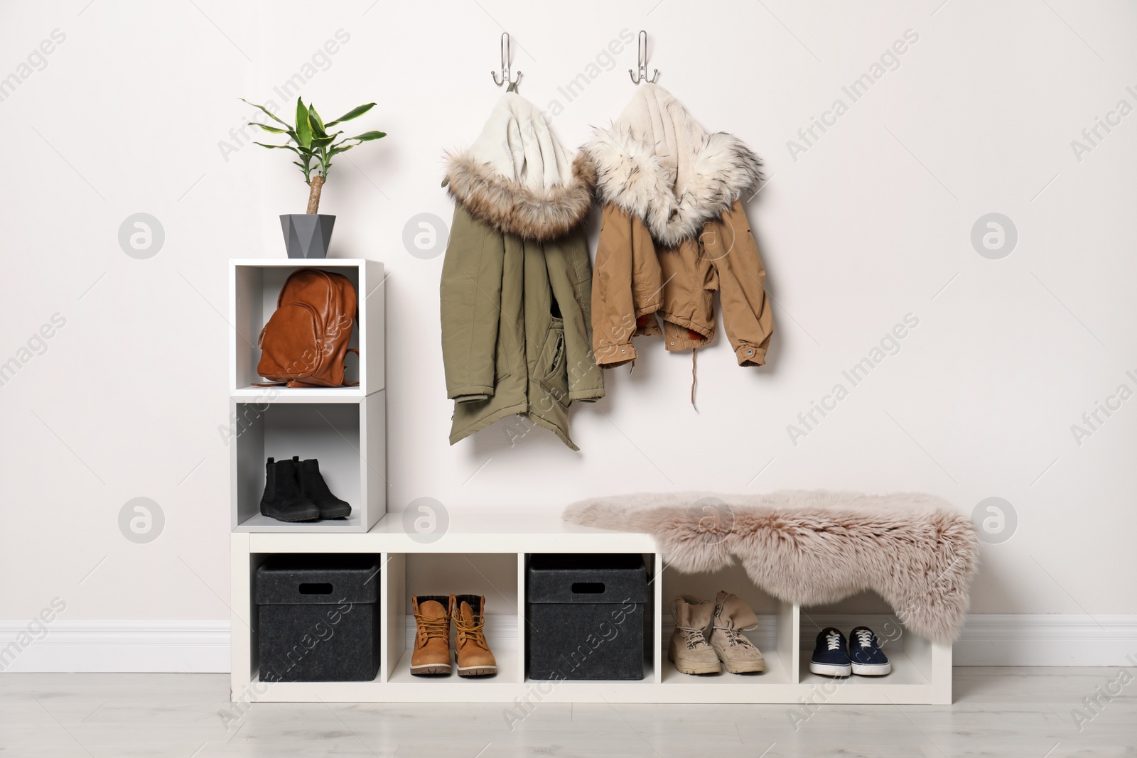 Photo of Modern hallway interior with hanging clothes and shoe rack