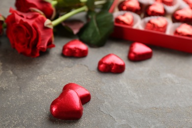 Photo of Heart shaped chocolate candies on grey table