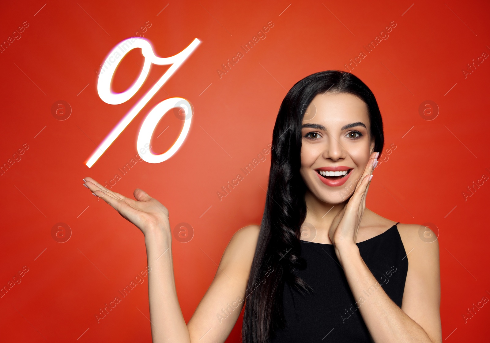 Image of Discount offer. Happy woman showing percent sign on red background