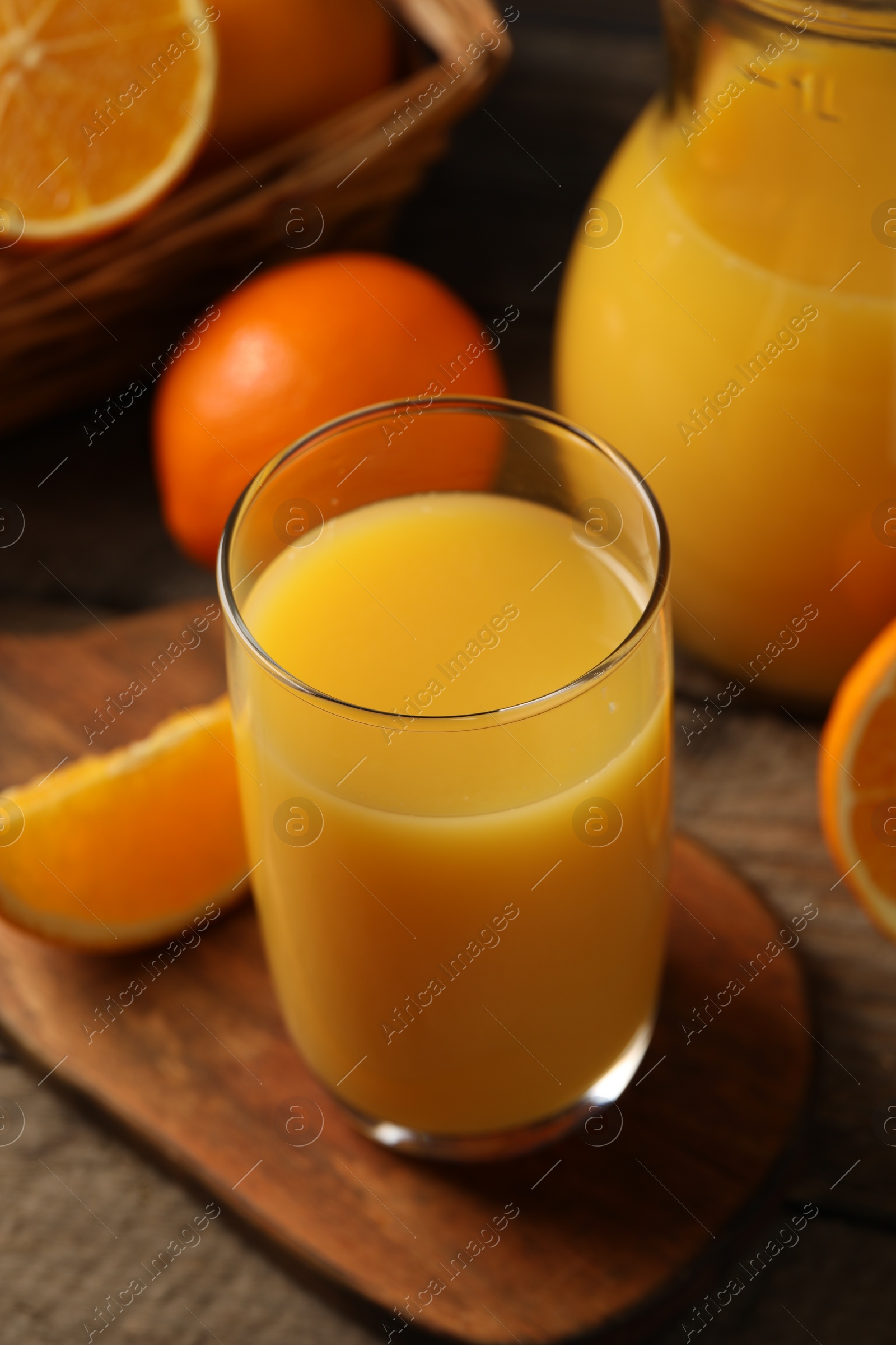 Photo of Tasty fresh oranges and juice on wooden table, closeup