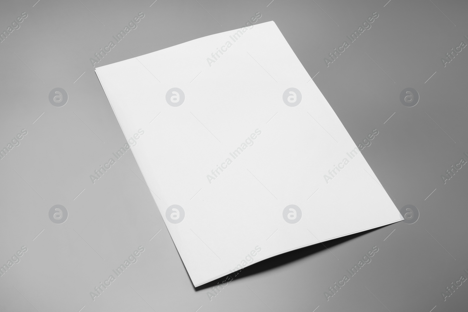 Photo of Blank paper sheets for brochure on grey background. Mock up