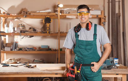 Professional carpenter with set of tools in workshop