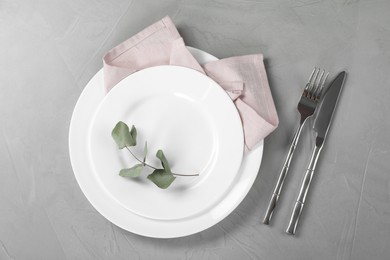 Photo of Stylish setting with elegant cutlery on grey table, top view