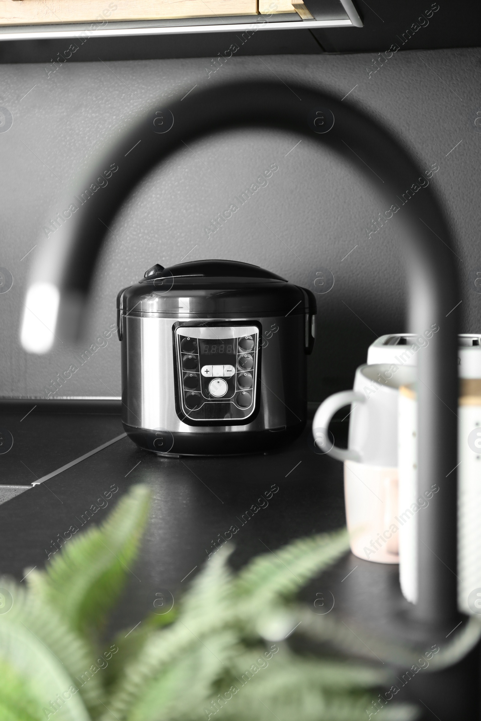 Photo of Modern multi cooker in kitchen. Domestic appliance