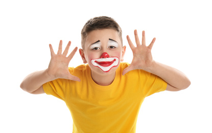 Photo of Preteen boy with clown makeup on white background. April fool's day
