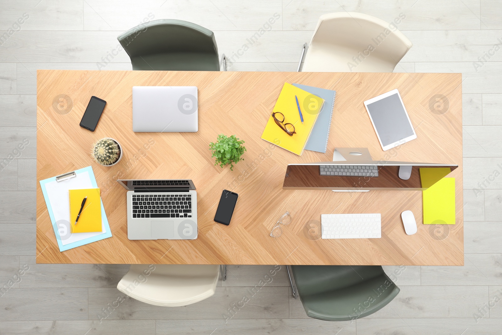 Photo of Modern office table with devices and chairs, top view