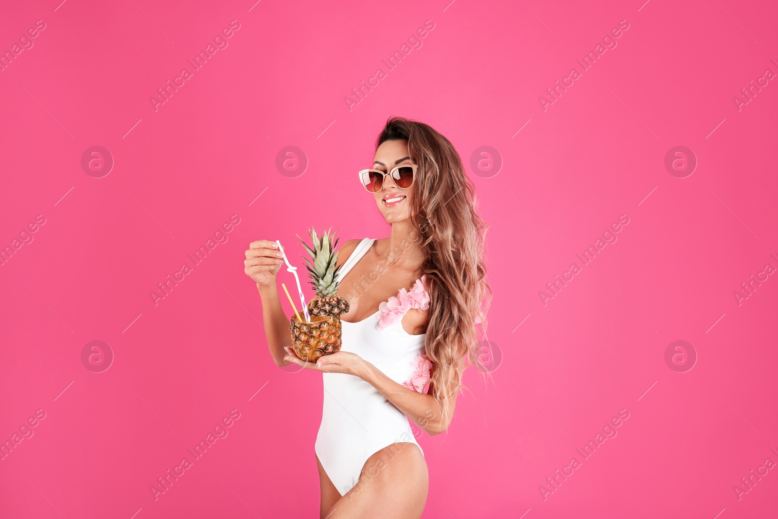Photo of Pretty sexy woman in stylish bikini with cocktail on color background