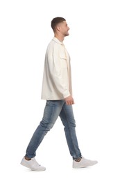 Man in casual outfit walking on white background