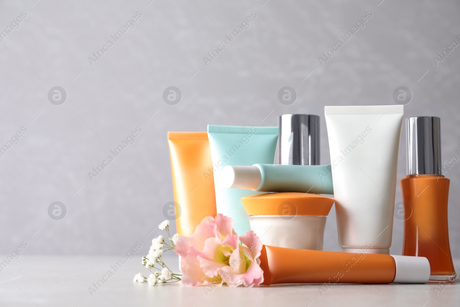 Photo of Set of luxury cosmetic products on light table. Space for text