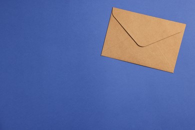 Photo of Envelope made of parchment paper on blue background, top view. Space for text