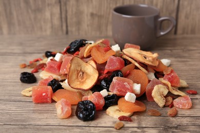 Different tasty dried fruits on wooden table