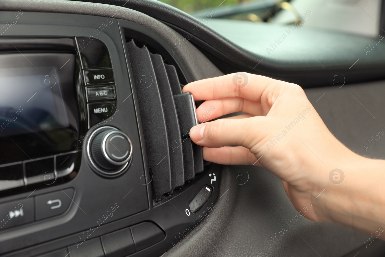 Photo of Woman adjusting air conditioner in car, closeup