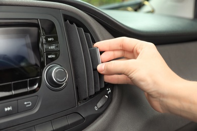 Photo of Woman adjusting air conditioner in car, closeup