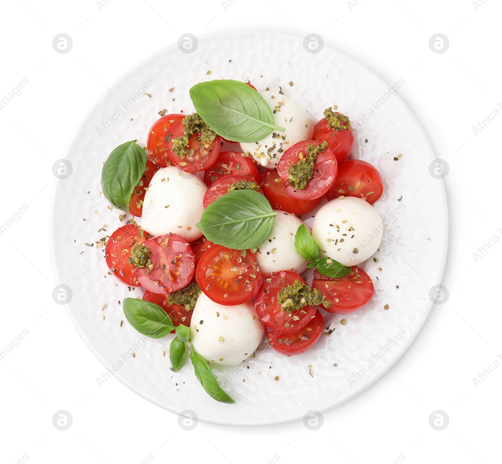 Photo of Plate of tasty salad Caprese with tomatoes, mozzarella balls and basil isolated on white, top view