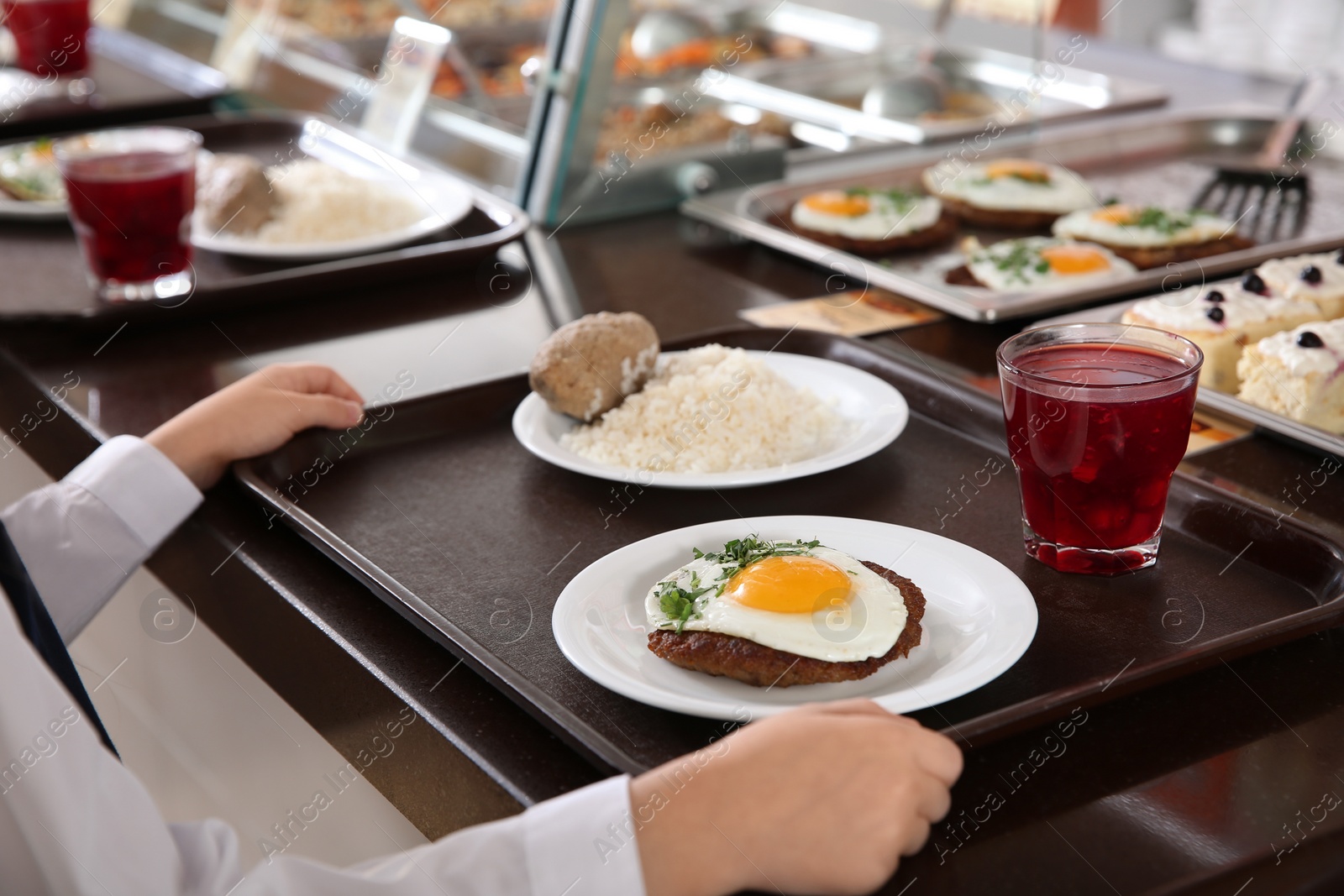 Photo of Girl near serving line with healthy food in school canteen, closeup