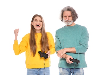 Mature man and young woman playing video games with controllers isolated on white