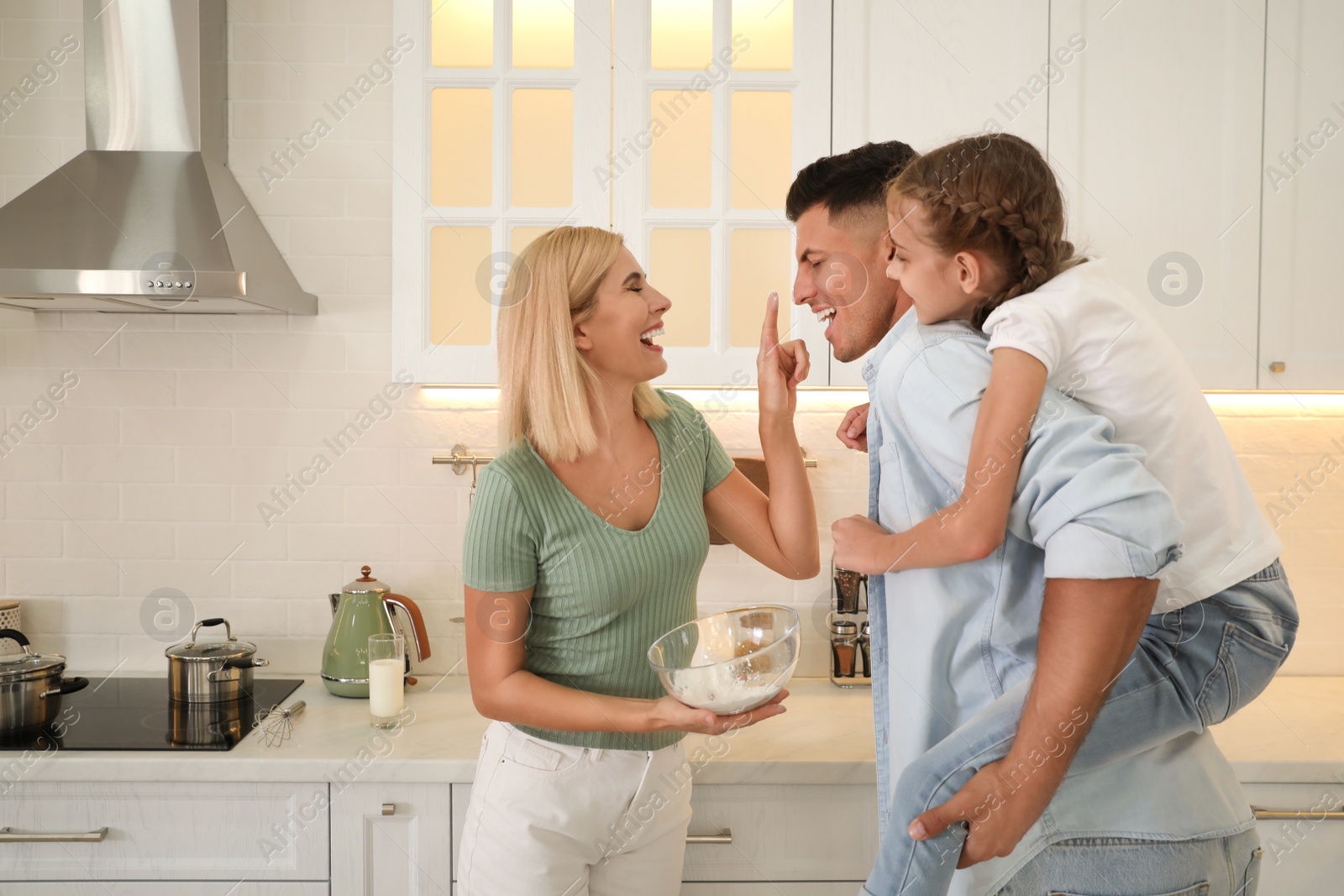 Photo of Happy family cooking together in modern kitchen