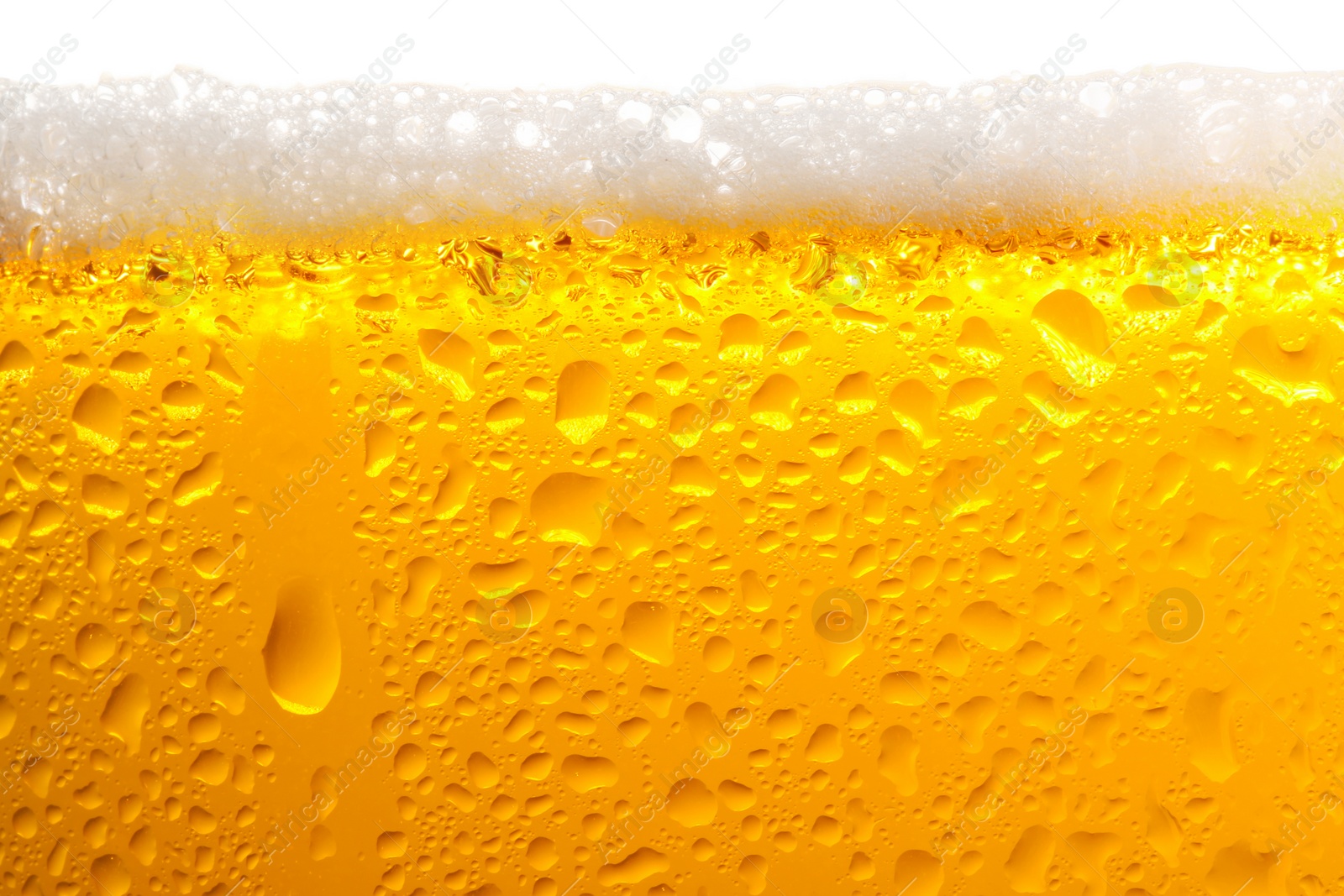 Photo of Glass of tasty cold beer with foam and condensation drops on white background, closeup