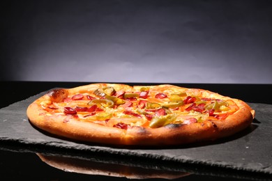 Delicious pizza Diablo on slate board against grey background