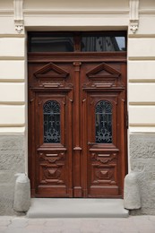View of building with big vintage wooden door. Exterior design