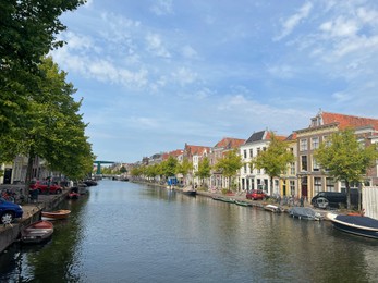 Photo of Beautiful view of buildings near canal and boats in city