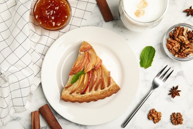 Delicious apple pie served on white marble table, flat lay