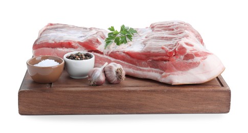 Piece of raw pork belly, parsley, garlic and spices isolated on white