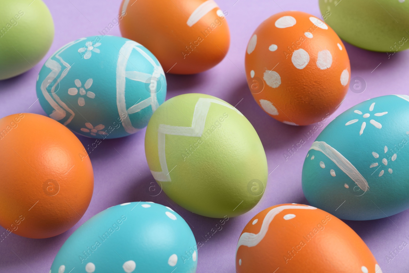 Photo of Many beautiful painted Easter eggs on color background, closeup