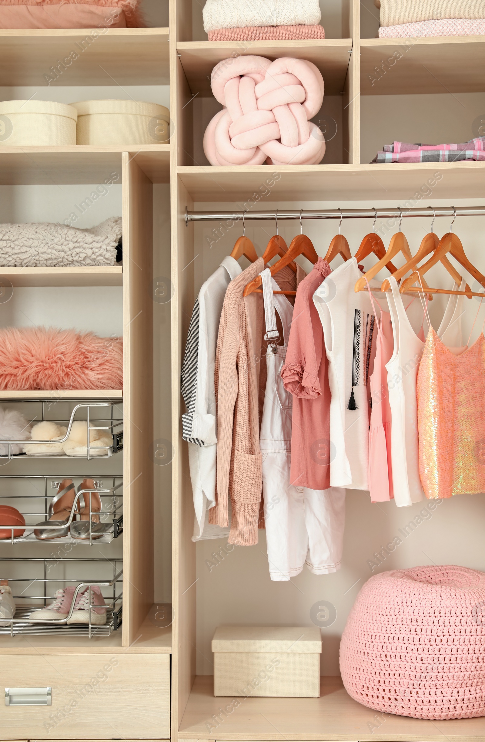 Photo of Stylish clothes, shoes and home stuff in wardrobe closet