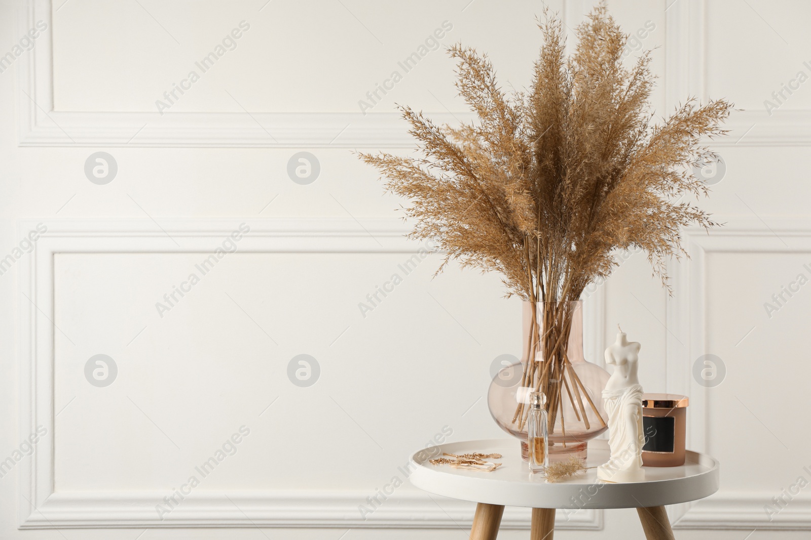 Photo of Venus De Milo candle on white table in room, space for text. Stylish decor