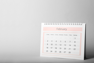 Photo of Paper calendar on grey background, space for text. Planning concept