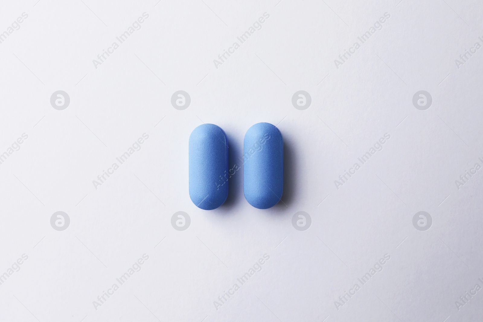 Photo of Pills on white background, top view. Potency problem