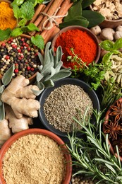 Photo of Different fresh herbs and spices as background, top view