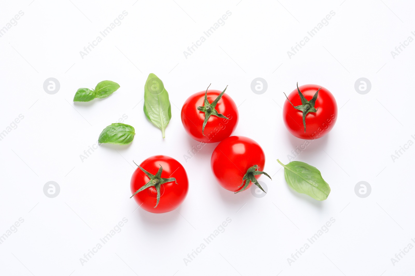 Photo of Composition with ripe cherry tomatoes and basil leaves on white background, top view